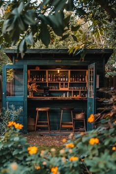 an outdoor bar with two stools in front of it