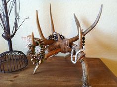 an animal made out of antlers on top of a wooden table