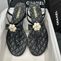 Chanel 2023 Black Quilted Leather Thong Sandals With Bow Camellia Cc Logo. Size 39= 8.5 Us Brand New In Box With Dust Bag. Elegant Leather Flip Flops With Branded Insole, Luxury Sandals With Single Toe Strap For Spring, Designer Black Toe Post Sandals, Designer T-strap Sandals For Summer, Designer Toe Post Sandals, Designer Toe Post Sandals For Spring, Luxury T-strap Sandals For Evening In Spring, Designer Flip Flops For Summer, Luxury Flip Flops