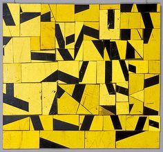 a yellow and black abstract painting on display