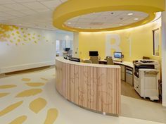 an office with yellow and white decor on the walls