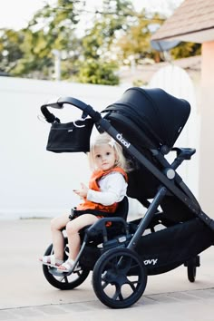 a small child sitting in a stroller