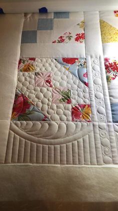 a close up of a quilt on a bed