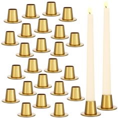 a group of gold candles with one candle lit in the middle and several on each side