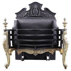 an ornately decorated black and gold bench with four candles on the back, against a white background