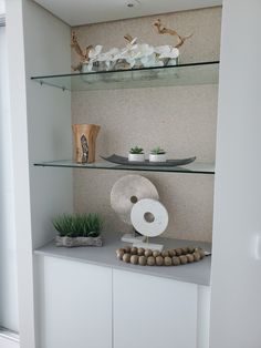 the shelves are filled with vases, plates and other decorative items on top of them