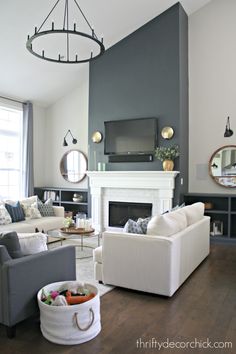 a living room filled with furniture and a flat screen tv mounted on the wall above a fireplace