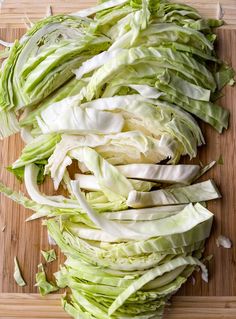 chopped lettuce sitting on top of a cutting board