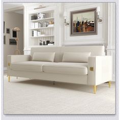 a living room with white furniture and a painting on the wall above it's couch