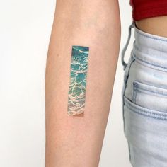 a woman's arm with a small piece of paper on the left side of her arm