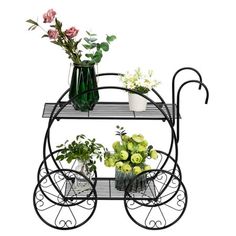 a metal cart with flowers and vases on it