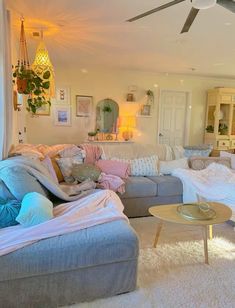 a living room filled with furniture and lots of pillows on top of it's couches