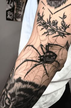 a man with a spider tattoo on his arm