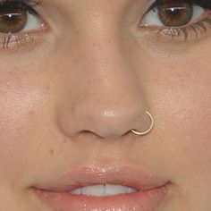 a woman with a nose piercing on her nose