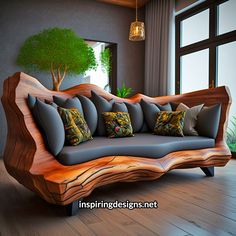 a couch made out of wood with pillows on it in front of a large window