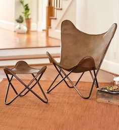 two leather chairs sitting on top of a rug