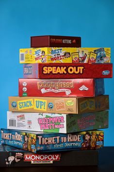 a stack of board games sitting on top of each other in front of a blue background