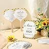 the table is set with place cards, flowers and napkins for guests to eat