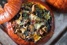 two stuffed pumpkins sitting on top of a table next to each other with different toppings