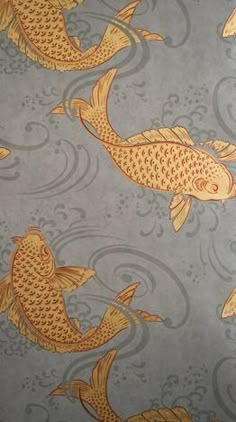 two gold fish on a gray background with swirls and bubbles in the water,