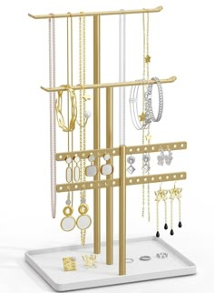 a gold jewelry rack with many different necklaces and earrings hanging from it's sides