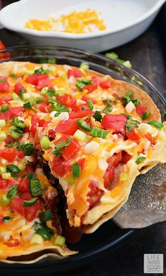 an omelet with tomatoes, green onions and cheese