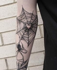 a person with a spider web tattoo on their arm