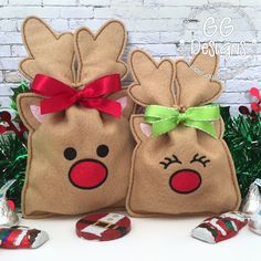 two christmas bags with reindeer faces on them