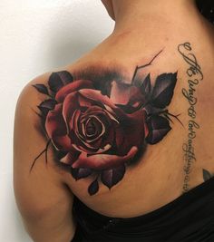 a woman with a rose tattoo on her back