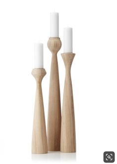 three wooden candlesticks on a white background