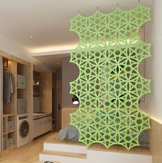 an artisticly designed room divider in the middle of a living area with washer and dryer