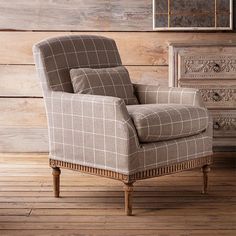 a chair sitting on top of a wooden floor next to a dresser