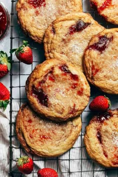 strawberry shortcakes on a cooling rack with fresh strawberries