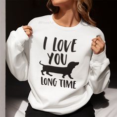 New! I Love You Long Time Dachshund Dog Graphic Sweatshirt. Sizing Is Unisex. Pullover Fleece Crewneck Sweatshirt With Long Sleeves. Ribbed Wrists & Waistband. Warm And Cozy Cotton/Polyester Blend. Style # Funny Humor Pun Love Pet Parent Dog Dad Mom Animal Lover Owner Park Walker Sausage Wiener Dog Breed Doxie Puppy Sayings Spring Autumn Fall Winter Mens Womens Teens Casual Cute Large Graphic Custom Clothing Relaxed Baggy Comfy Loungewear Sleepwear Lounge Sweater Light Classic Solid Color Vday V Dachshund Mom Shirt, Puppy Sayings, Christy Hoodie Brandy Melville, Pink Champion Hoodie, White Champion Hoodie, Barbie Sweatshirt, Comfortable Hoodies, Dog White, Animal Sweater