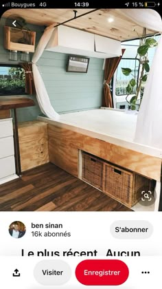 the inside of a mobile home with wood flooring and white walls, including an open window