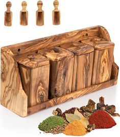 an assortment of spices and seasonings in wooden containers on a white background with five spice shakers next to it