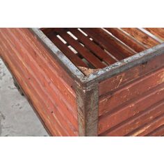 an old wooden crate with rusted paint and metal bars on the bottom is shown