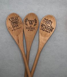 three wooden spoons with engraved names on them