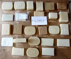 several different types of soaps are shown on a brown paper bag with white labels