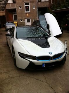 a white car parked in front of a house