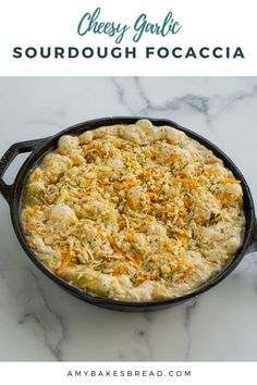 cheesy garlic sourdough focaccia in a cast iron skillet