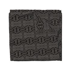 a black and white print pocket square on a white background, with small dots in the center