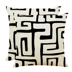 two black and white pillows with square shapes on the front, one is made out of fabric