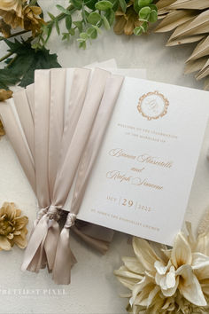 the wedding stationery is laid out next to flowers