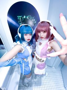 two women dressed in cosplay standing next to each other