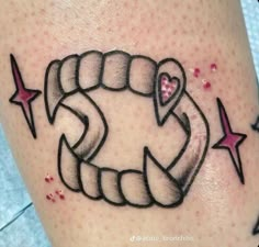 a tattoo on the leg of a woman with an arrow and heart in it's center