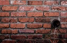 a brick wall with a hole in it