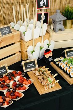 an assortment of sushi and other foods are on display at a party or gathering