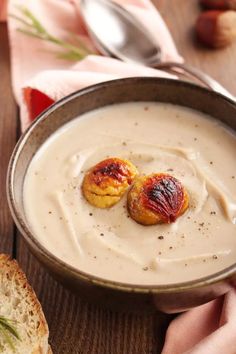 two pieces of bread sit in a bowl of cream