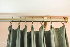 green curtains hanging from a metal rod